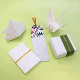 Origami cranes and gift-wrapped boxes on a green background